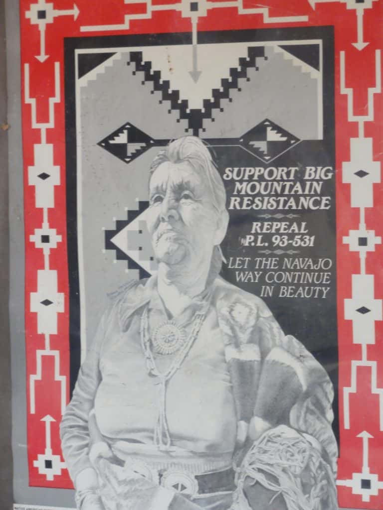 A poster with an image of Katherine Smith surrounded in a border evoking a woven rug, and the words Support Big Mountain Resistance, Repeal P.L.93-531, Let the Navajo Way Continue in Beauty.